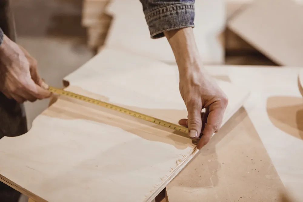 Measuring a board with a tape measure